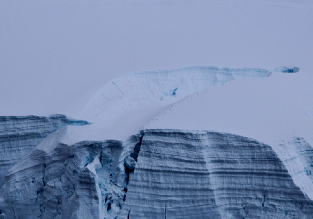 Snowy glacier with visible crevasse